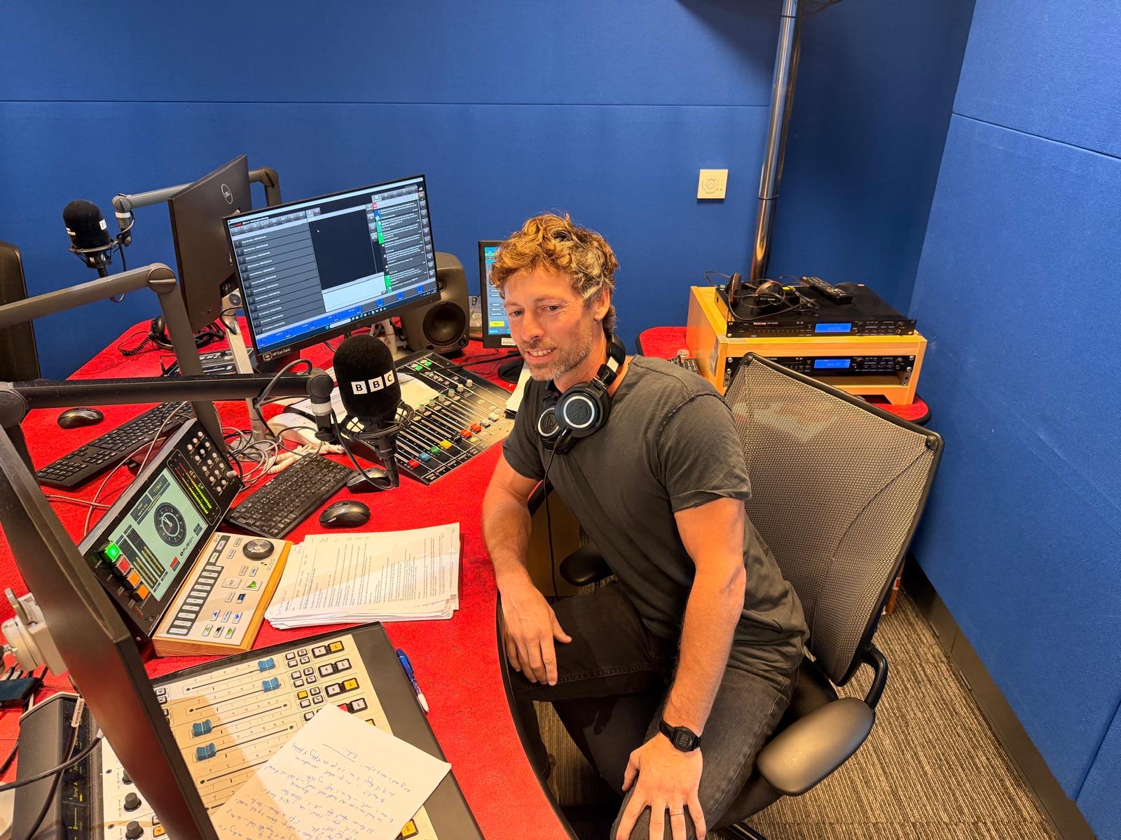 Isaac at the desk in the BBC Radio Northampton studio